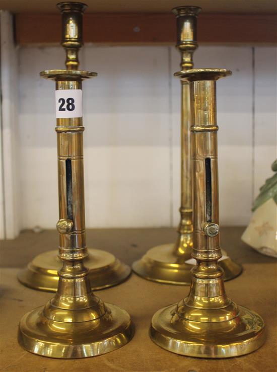 Two pairs of Regency brass candlesticks